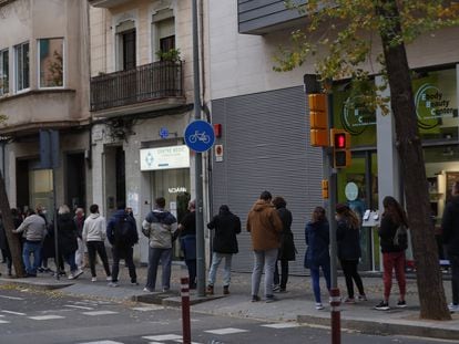 People wait in line for a coronavirus test at a private clinic in Spain.