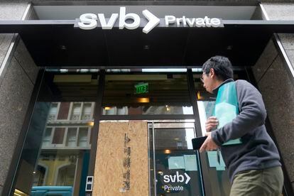 A pedestrian passes a Silicon Valley Bank branch in San Francisco