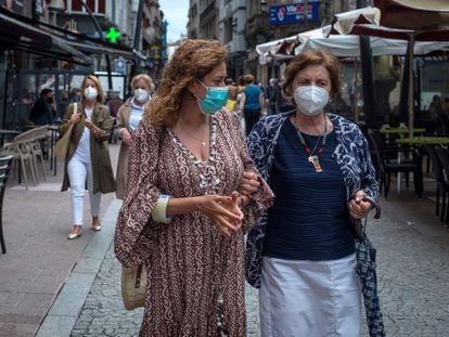 Two women wear face masks in a street in the center of Ourense.