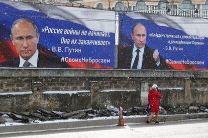 Signs with the face of Vladimir Putin in Simferopol, Crimea, on Friday. The text on the left says: "Russia does not start wars, it ends them."