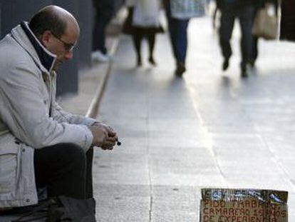 An out-of-work waiter begging on the streets of Valencia.
