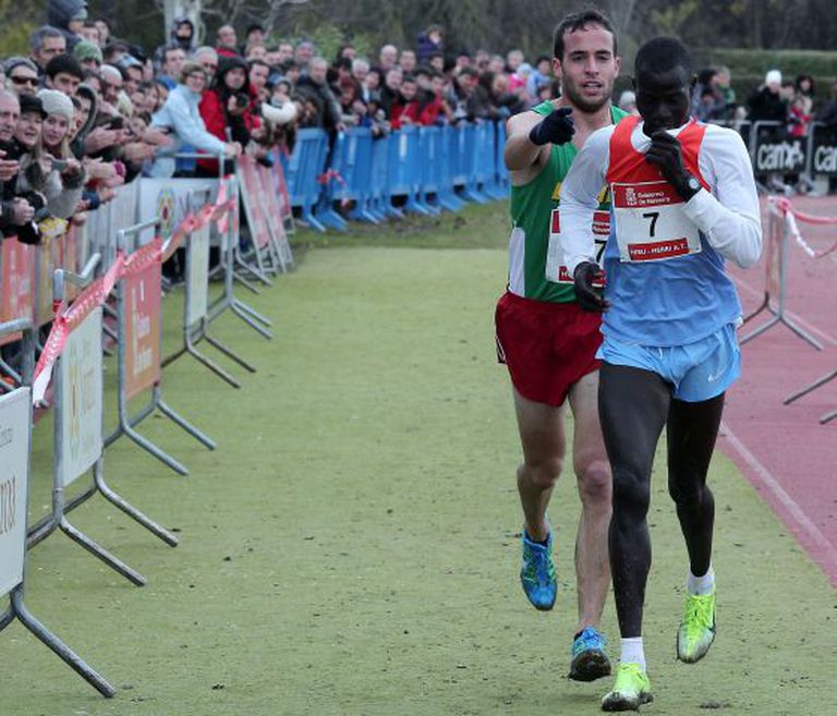 Fernández Anaya helps Mutai toward the line.