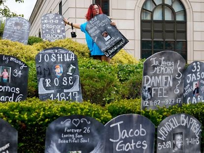 Cardboard gravestones with the names of victims of opioid abuse are set up outside the courthouse where the Purdue Pharma bankruptcy is taking place in White Plains, New York, in August 2021.