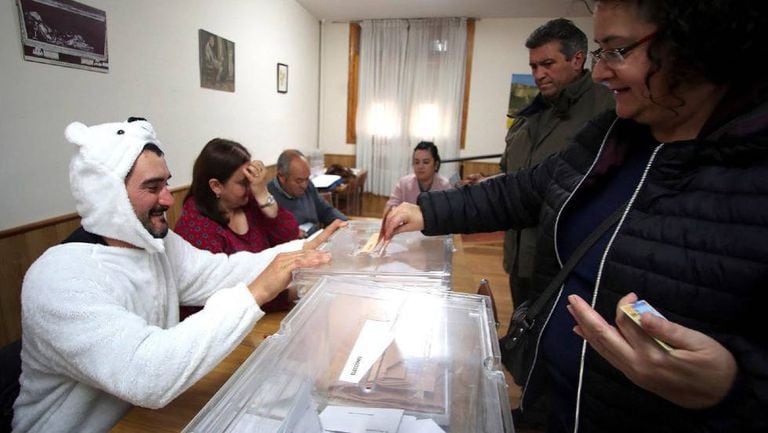 A man in a polar bear suit presides over a polling station in El Burgo de Osma.
