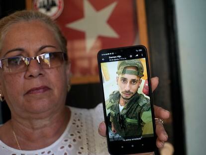 Marilin Vinent holds up a photo of her son dressed in military fatigues, on Sept. 8, 2023. Vinent said that her son traveled in July to Russia after being promised work in a construction job, but that he was one of the Cubans recruited to fight in the war.