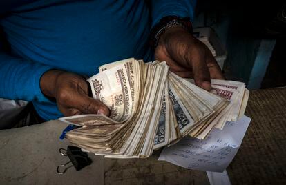 An ordinary Cuban with a handful of pesos.