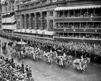 The Coronation procession on the return from Westminster Abbey to Buckingham Palace. The State Coach passes Sir Winston Churchill's coach, which had to fall out altogether and was held up outside Canada House.   