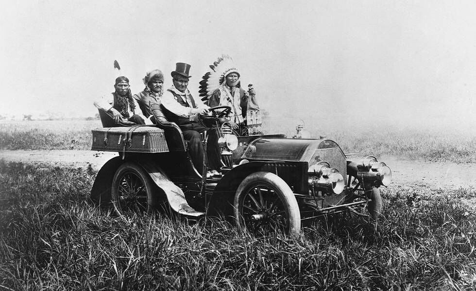 The Apache leader Geronimo and three other Indigenous men on a car, circa 1904, placed there by American captors. 