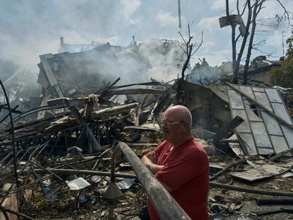 A man watches as emergency service personnel work at the site of a destroyed building after a Russian attack in Odesa, Ukraine, Thursday, July 20, 2023. Russia pounded Ukraine’s southern cities, including the port city of Odesa, with drones and missiles for a third consecutive night in a wave of strikes that has destroyed some of the country’s critical grain export infrastructure. (AP Photo/Libkos)