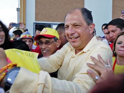 Opposition candidate Luis Guillermo Solís greets his supporters.