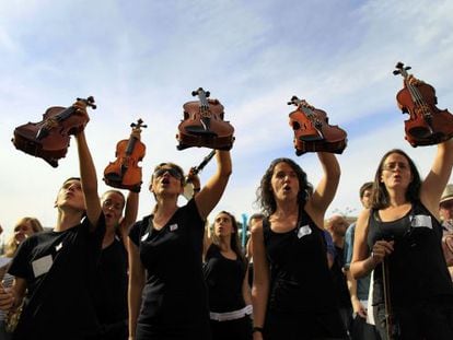 Students and teachers stage a protest against spending cuts for municipal music schools in Madrid. 