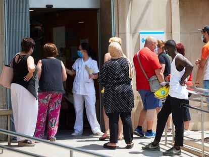 People waiting outside Prat de la Riba primary healthcare center in Lleida on Tuesday.