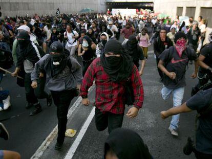 Masked demonstrators at a protest on October 2, 2013 in Mexico City.