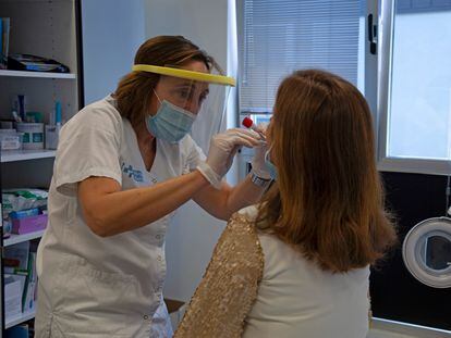 A doctor from the sentinel network in La Rioja, Spain, takes a sample from a patient.