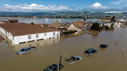 Floodwaters surround homes and vehicles in the community of Pajaro in Monterey County, California