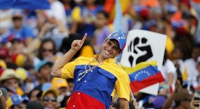 Opposition candidate Henrique Capriles encourages supporters on Sunday in Caracas.