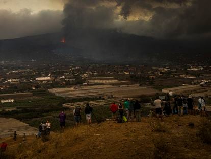 People observe the volcano from La Laguna on Tuesday.