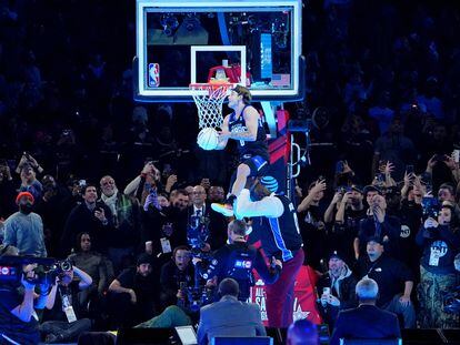 Osceola Magic guard Mac McClung (0) dunks the ball over former basketball player Shaquille O'Neal during the slam dunk competition during NBA All Star Saturday Night at Lucas Oil Stadium.