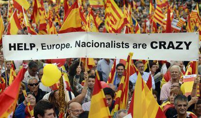 People opposed to the independence of the Catalonia hold Catalan and Spanish flags during Spain&#039; s National Day in Barcelona on Friday. 