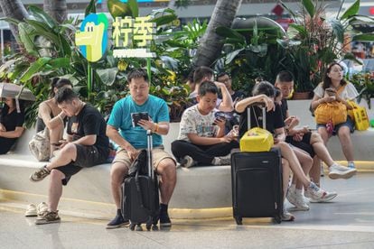 People using their smartphones at the popular Guangzhou South railway station in Guangdong province, China.
