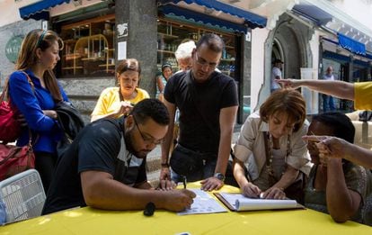 Opponents of President Nicolás Maduro sign the petition for a recall referendum.