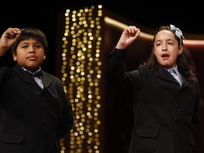 Children at Madrid's San Ildefonso school sing out the winning lottery numbers.