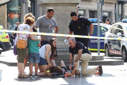 A victim of the attack is attended to by passersby.