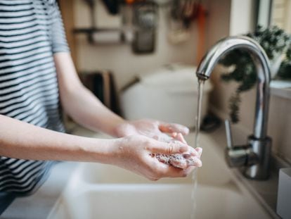 A person washes their hands.