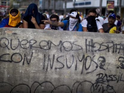 A group of demonstrators hold a march in Caracas on Sunday.