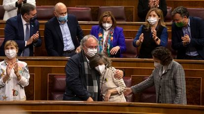Socialist lawmaker Maria Luisa Carcedo, who pushed for an euthanasia law when she was health minister, is embraced by fellow deputies after the vote.