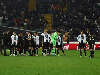 Referee Enzo Maresca, eight from left, match officials, right, and Udinese's players gather as the Italian Serie A soccer match between Udinese and AC Milan is suspended, at the Friuli stadium in Udine, Italy, Saturday, Jan. 20, 2024.