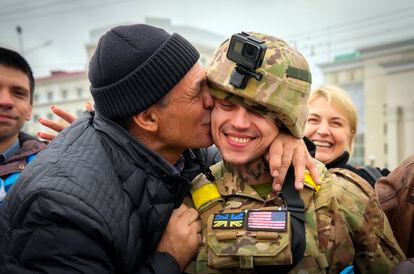 A resident of Kherson kisses a Ukrainian soldier after the Russian withdrawal from the area.
