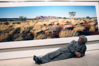 Wim Wenders poses with one of his images at the Fundación Sorigué.
