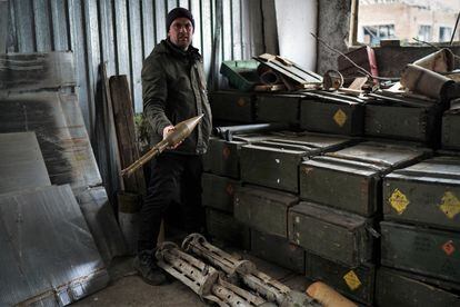 Sergei Yatsenko displays ammunition left by the Russians after their month-long occupation of the farm.