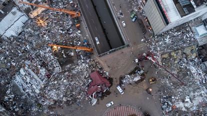 An aerial photo taken by a drone shows emergency personnel during a search and rescue operation at the site of a collapsed building in Iskenderun.
