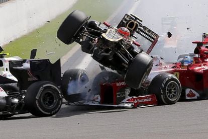 Romain Grosjean&#039;s Lotus (center) flies over Fernando Alonso&#039;s Ferrari at Spa on Sunday. 