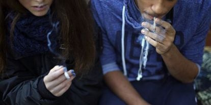 A 15-year-old girl smokes alongside her 17-year-old friend in Madrid.