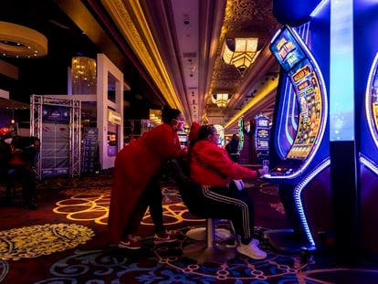 American football supporters play a slot machine in Mandalay Bay Hotel and Casino in Las Vegas, Nevada, USA, 10 February 2024.