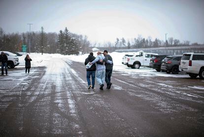 Thomas Rhodes, center, walks out of the Minnesota Correction Facility in Moose Lake, Minn., on Friday, Jan. 13, 2023.