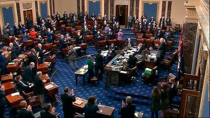 Senators applaud ahead of the final vote of Covid-19 relief bill on Saturday.