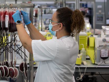 A worker handles samples at a blood transfusion center in the Madrid region.