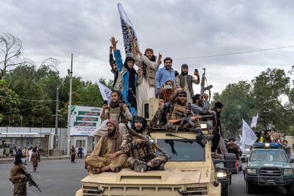 Taliban fighters celebrate one year since they seized the Afghan capital, Kabul, in front of the U.S. Embassy in Kabul, Afghanistan