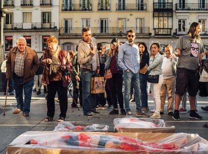 Activists in the Puerta del Sol in Madrid stage a protest called “Packaged” in which they emulate the state of meat wrapped in plastic.