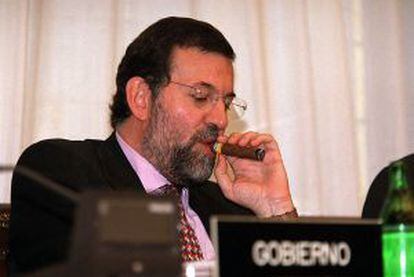 Then-Interior Minister Mariano Rajoy lights a cigar at an official event in 2001.