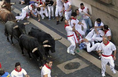 Runners do their best to avoid the bulls during the last day of Sanfermines on Sunday.