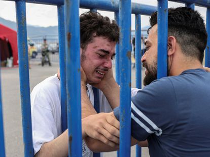 Syrian survivor Fedi, 18, cries as he reunites with his brother Mohammad, who came to meet him from Italy, at the port of Kalamata.