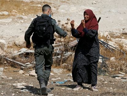 A Palestinian woman argues with an Israeli soldier during the demolition of a house near Hebron, West Bank; September 2020.