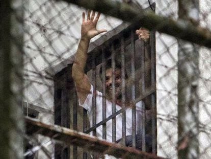 Leopoldo L&oacute;pez greets a crowd from a window at the military prison Ramo Verde in Caracas. 