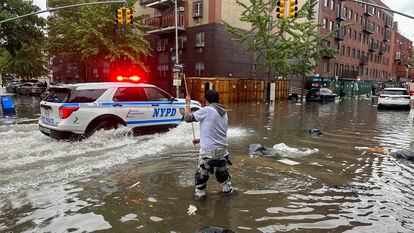 A man tries to clear a drain amid flooding last week in Brooklyn, New York.