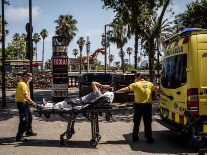 Paramedics help a patient into an ambulance during a heat wave in Barcelona, Spain, on Monday, July 18, 2022.